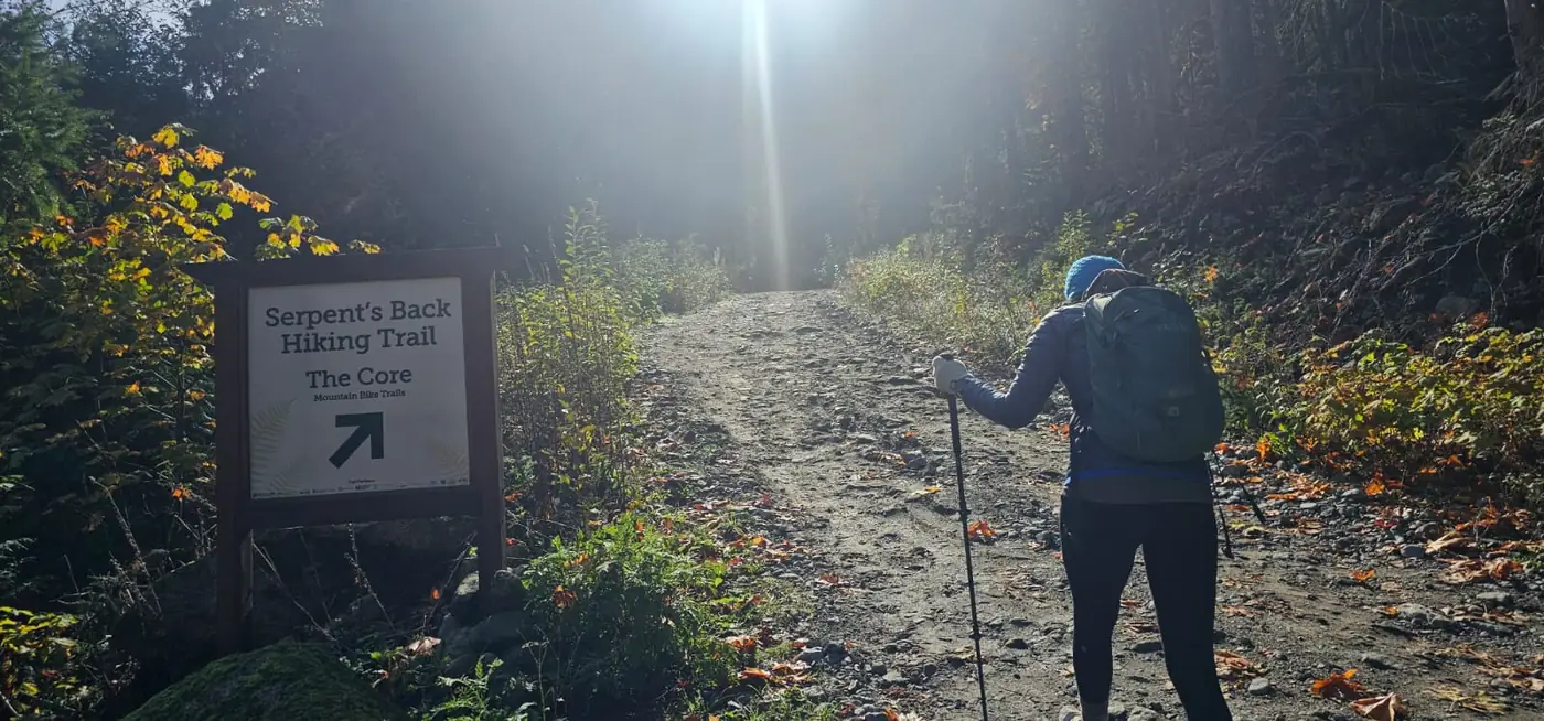 Hiker following the signed gravel approach to Serpent’s Back from our roadside starting point